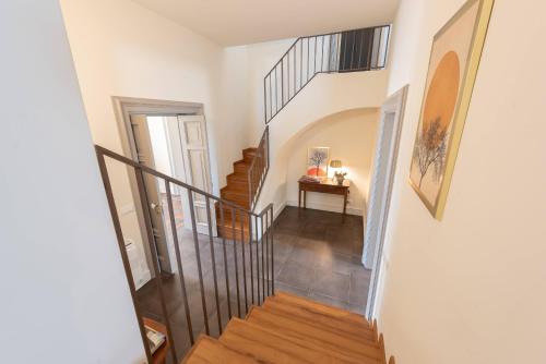 a hallway with a spiral staircase in a home at Villa Ida - IsulaTravel in Frigintini