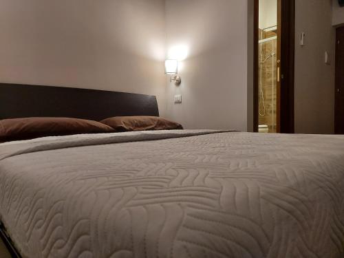 a bedroom with a large bed with a white comforter at I Tre Marchi Rooms Camera Sabbia in Termoli