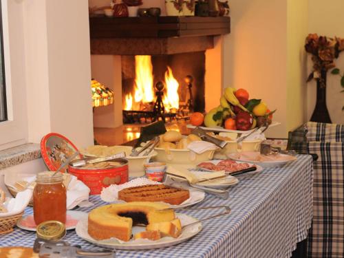 a table with food on it with a fireplace at Affittacamere Marisa in Valeggio sul Mincio