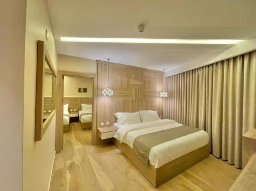 a bedroom with a large bed and a bathroom at Twins Boutique Hotel in Aqaba