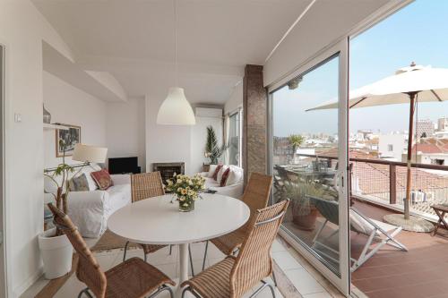 a living room with a table and chairs at Panoramic Faro Apartment in Faro