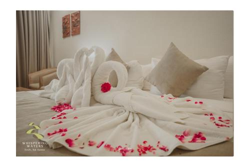 a bed with two swans made out of towels at Whispering Waters in Malayāttūr