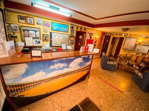a room with a large picture of a boat on the wall at Hotel Arunda II in Ronda