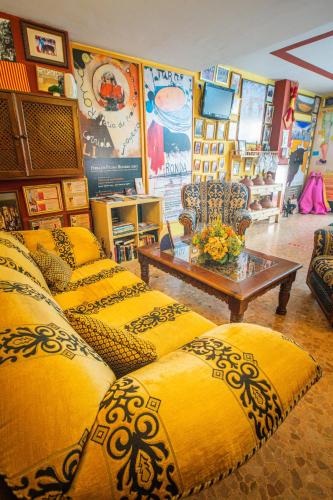 a living room with yellow pillows and a table at Hotel Arunda II in Ronda