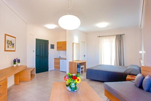 a living room with a bed and a couch at Silver Beach Hotel & Apartments in Gerani Chanion