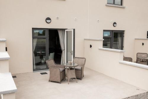 a patio with chairs and a table in a building at Clanard Court Hotel in Athy