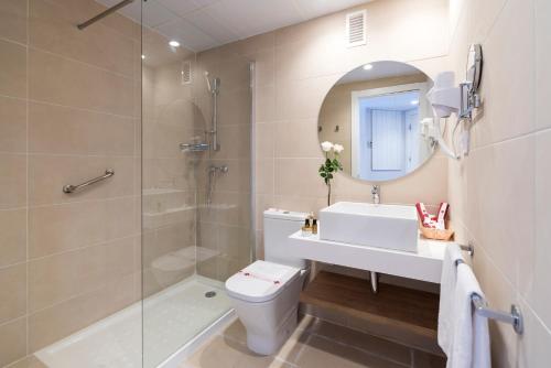 Un baño con inodoro, ducha y lavabo. en Apartamentos Guitart, en Lloret de Mar