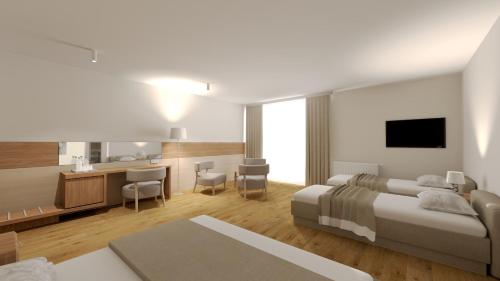 a hotel room with a bed and a desk and a kitchen at Olymp IV in Kołobrzeg