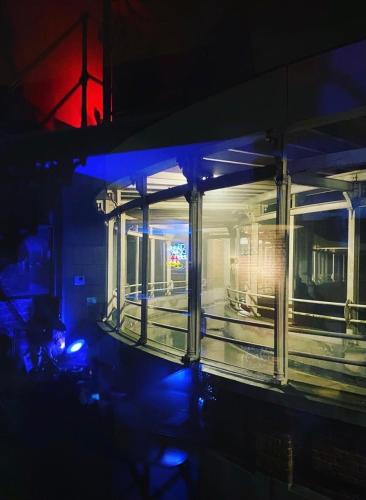 a lit up building at night with blue lights at Secret Room votre LOVE ROOM coquine et insolite en espace privatif a Tournai in Tournai