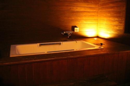 a bath tub with a light on top of it at Hotel Room in Miyazaki