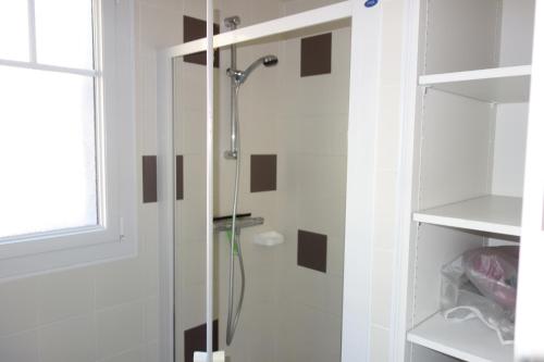 une douche avec une porte vitrée dans une salle de bain dans l'établissement Au gite des viviers de la houle, à Cancale