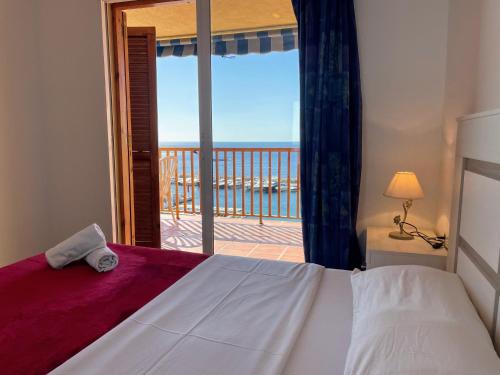 a bedroom with a bed and a view of the ocean at Palo Mayor 21 in Altea