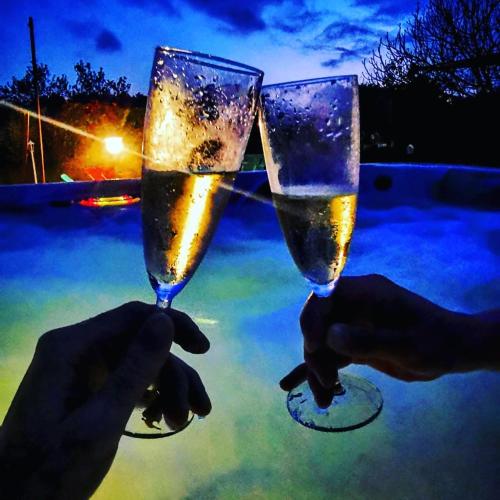 two people holding up two glasses of champagne at Bastide Provençale Les Mûriers d'Engaspaty in Seillans