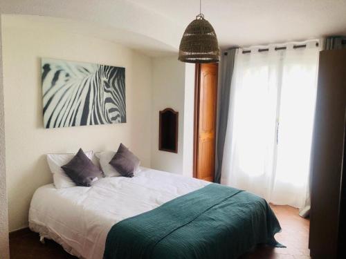 a bedroom with a bed with a zebra picture on the wall at Villa Vence in Vence
