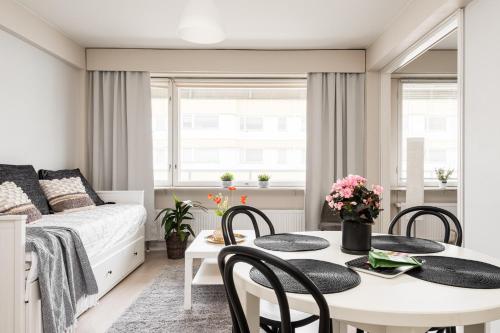 a bedroom with a bed and a table and chairs at Apartments Borg Antinkatu in Pori