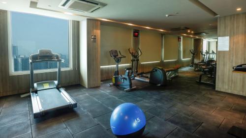 a gym with cardio equipment and a large window at Holiday Inn Gurugram Sector 90 by IHG in Gurgaon