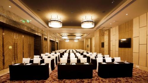 a conference room with tables and chairs in it at Holiday Inn Gurugram Sector 90 by IHG in Gurgaon