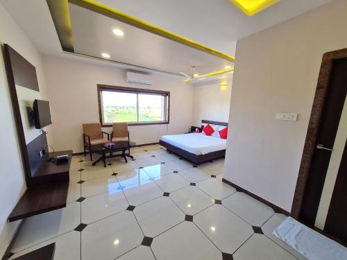 a bedroom with a bed and a tv in a room at HOTEL SHIV SHAKTI in Bhopal