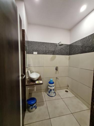 a small bathroom with a sink and a toilet at HOTEL SHIV SHAKTI in Bhopal