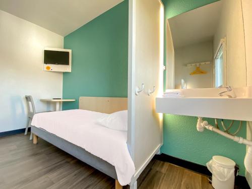 a bedroom with a bed and a sink and a mirror at hotelF1 Avranches Baie Du Mont Saint Michel in Saint-Quentin-sur-le-Homme