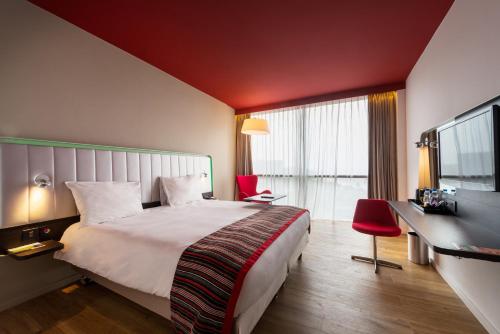a hotel room with a bed and a large window at Park Inn by Radisson Libreville in Libreville