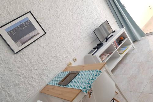 an overhead view of a room with a desk and a television at Front Beach Jandía Apartment in Morro del Jable