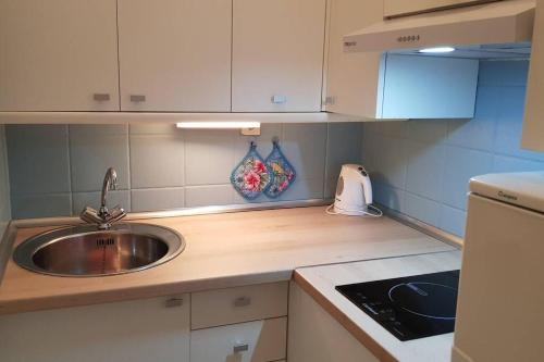 a kitchen with a sink and a counter top at Front Beach Jandía Apartment in Morro del Jable