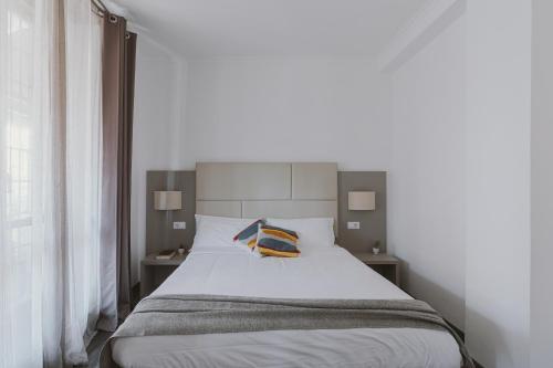 a bedroom with a white bed with two night stands at Residenza Il Giglio in Rome