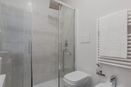 a bathroom with a toilet and a glass shower at Residenza Il Giglio in Rome