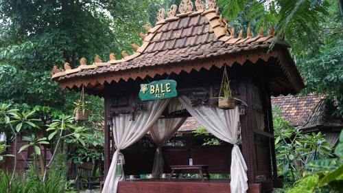 a gazebo with a sign that says bite at Cokro Hinggil - Traditional View in Sleman