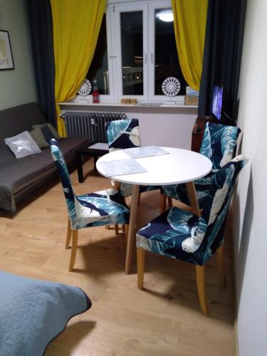 a living room with a table and two chairs at Good Time in Szczecin in Szczecin