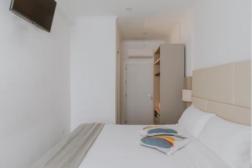 a bedroom with a white bed with two pillows on it at Residenza Il Giglio in Rome