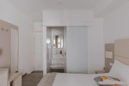 a white bedroom with a bed and a sink at Residenza Il Giglio in Rome