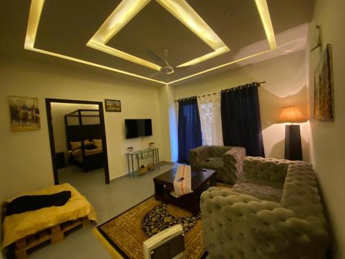 a living room with a couch and a chair at Serenity Corner in Islamabad