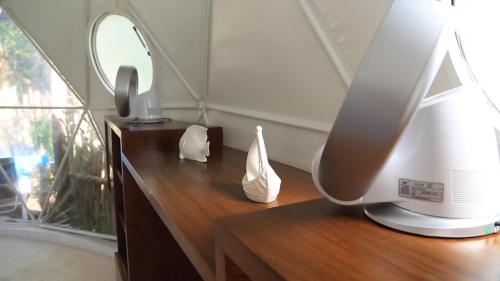 a desk with a computer monitor and a mirror at Glamping Tulum with private mini pool in Tulum