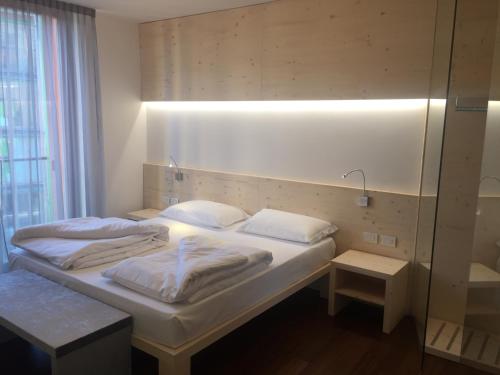 a bedroom with two beds and a mirror at Komodo short stay apartments in Trento