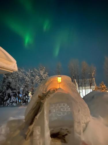 a snow igloo with a light on top of it at The Northern Light Apartment in Jukkasjärvi