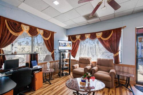 a living room with a couch and chairs and a tv at Hotel O Columbia Downtown near I-65 in Columbia