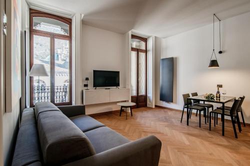 a living room with a couch and a table at Dome's Charme - The House Of Travelers in Como