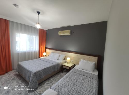 a hotel room with two beds and a window at Nostalgia World OTEL in Kızılot