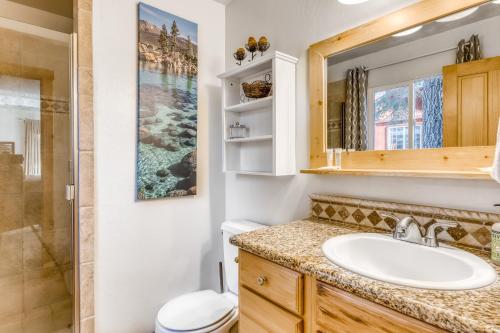 a bathroom with a sink and a toilet and a mirror at Lazy Bear Retreat in Mevers