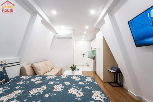 a bedroom with a bed and a living room at Merry House Imperia in Hai Phong