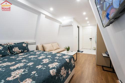 a small bedroom with a bed and a couch at Merry House Imperia in Hai Phong
