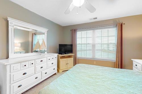 a bedroom with a white dresser and a mirror at Bethany Bay 2505 Harbor Dr in Ocean View