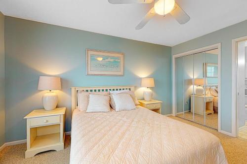 a bedroom with a bed with two lamps and a fan at Bethany Bay 2505 Harbor Dr in Ocean View
