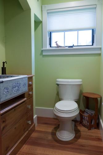 a bathroom with a white toilet and a window at The Gatehouse on Golden Hill in Lee