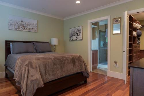 a bedroom with a bed and a walk in closet at The Gatehouse on Golden Hill in Lee