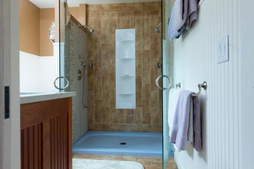 a shower with a glass door in a bathroom at The Gatehouse on Golden Hill in Lee