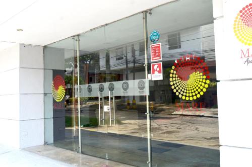 a glass window of a building with a sign on it at Hotel Mare Apartasuite in Cali