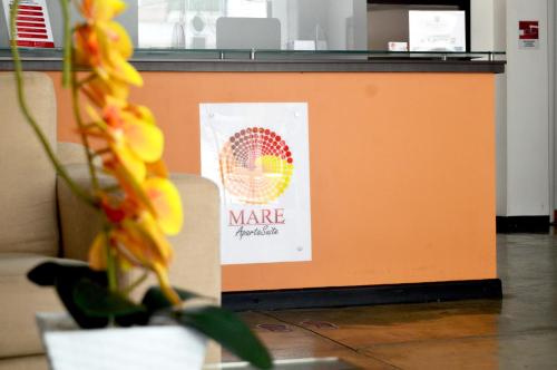 an orange counter with a sign on it at Hotel Mare Apartasuite in Cali